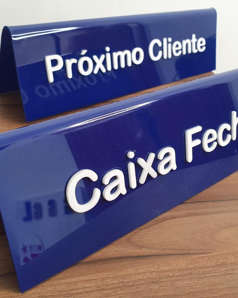 Placas de mesa em acrílico azul dobrado, com os avisos Próximo Cliente e Caixa Fechado em letras brancas
